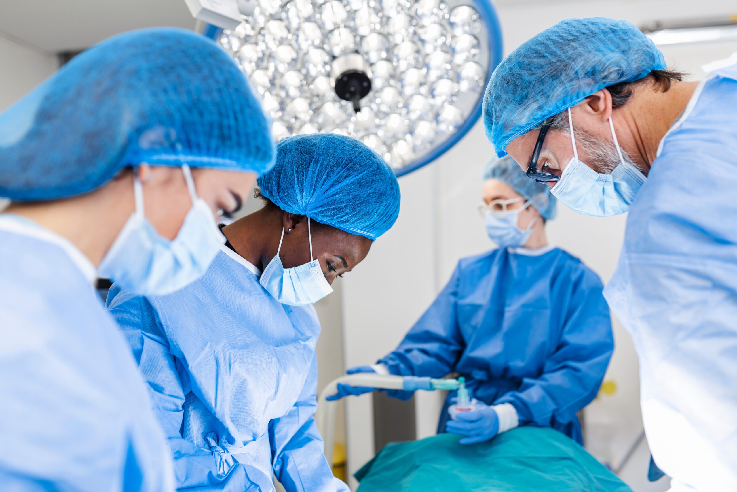 Operating room with a surgeon and nurses.